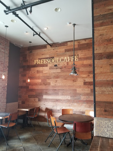 Freesoulcaffé's reclaimed wood wall with gold-stenciled lettering and steel track lighting